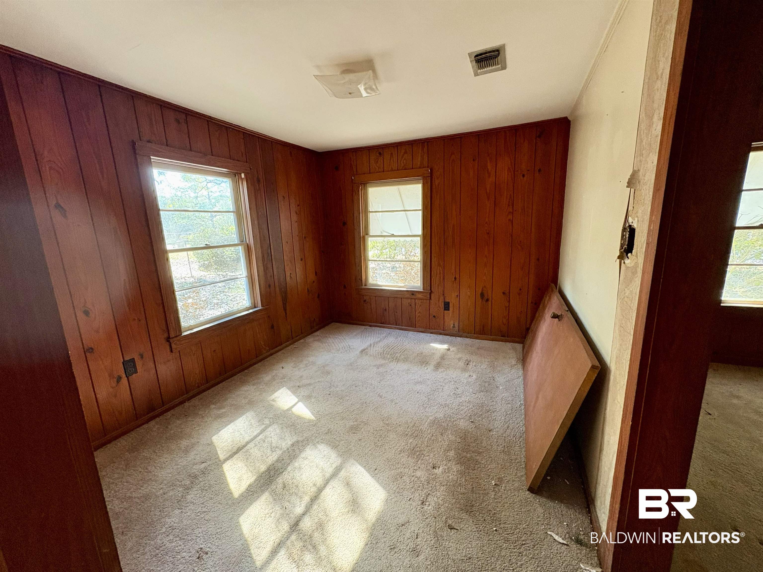 4060 Dickson Lane Mobile, AL 36618 - Photo 13 of 16 Unfurnished room with wooden walls and light carpet