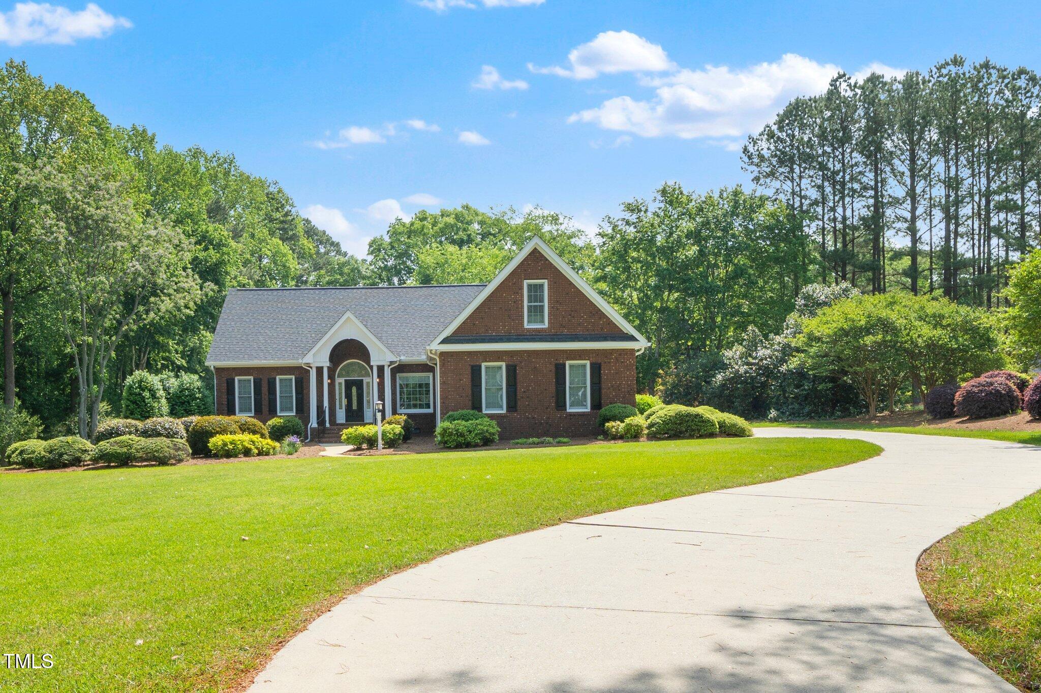 a front view of house with yard and green space