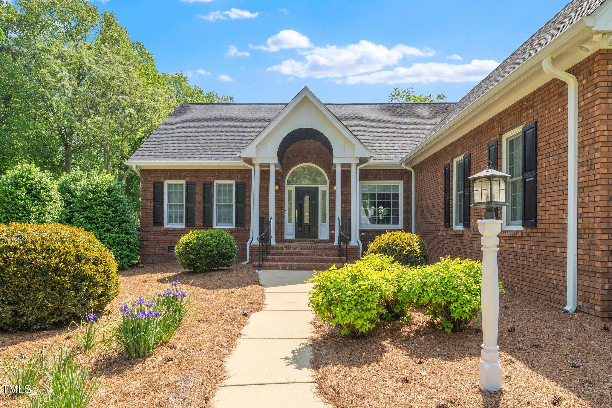 8733 Crowder Road Raleigh, NC 27603 - Photo 2 of 50 a front view of a house with garden
