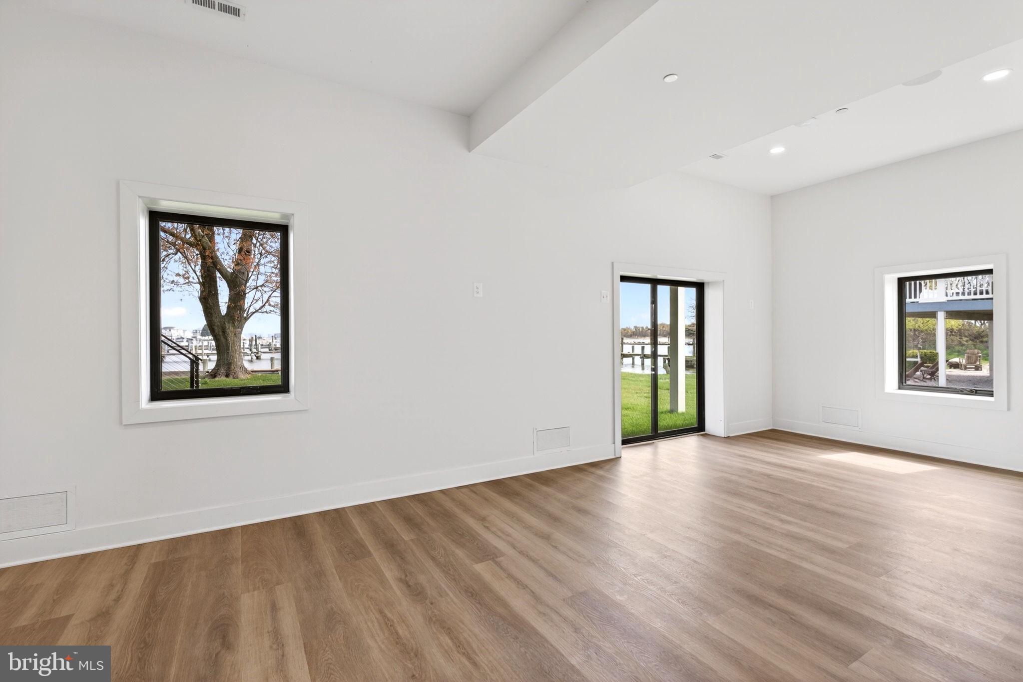 2708 6th Street Sparrows Point, MD 21219 - Photo 113 of 131 a view of an empty room with wooden floor and a window