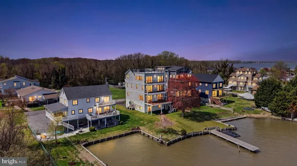 an aerial view of a house with a garden and lake view