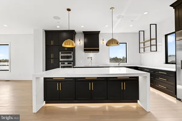 a spacious bathroom with a double vanity sink a mirror and a bathtub