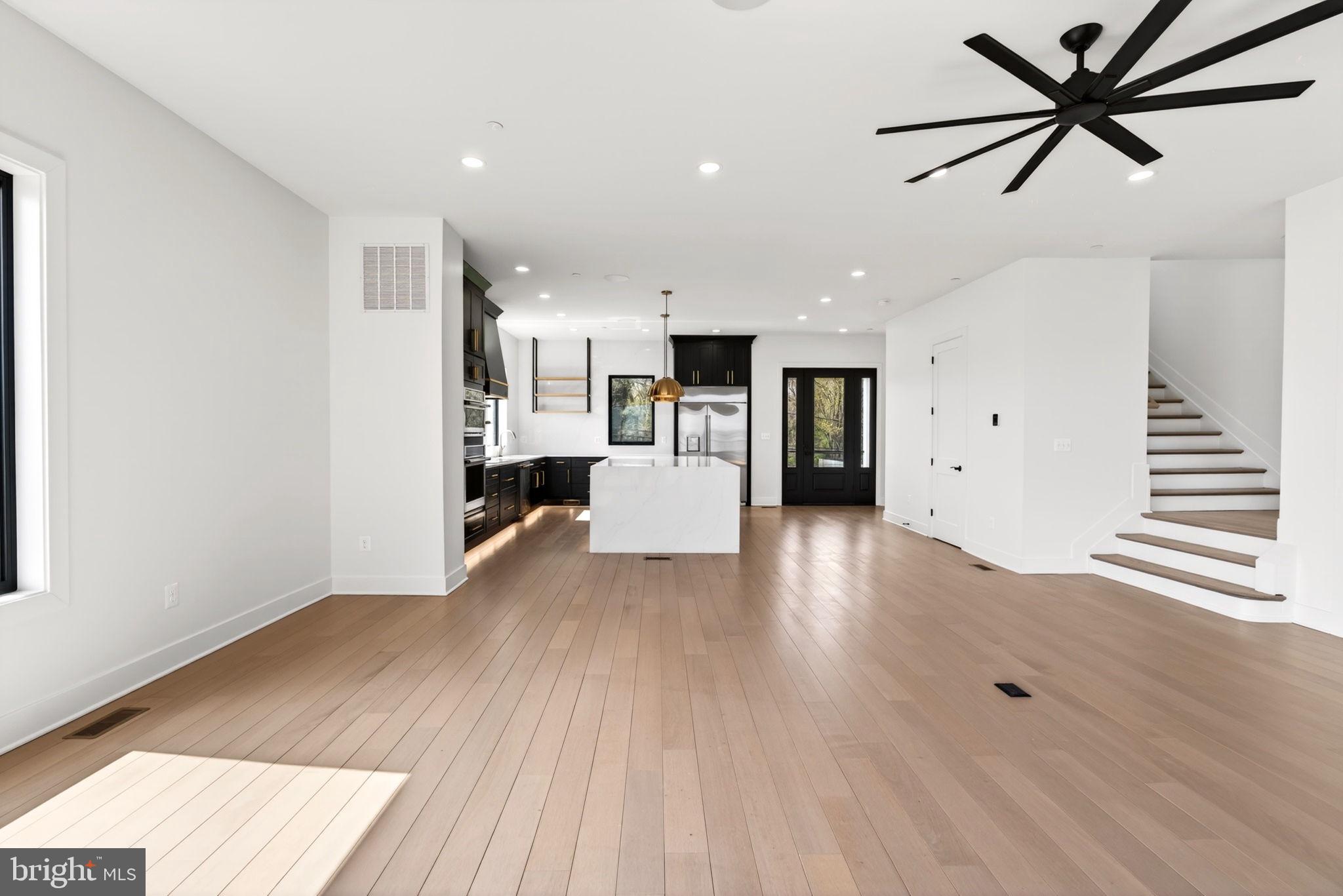 2708 6th Street Sparrows Point, MD 21219 - Photo 39 of 131 a view of a kitchen with wooden floor and a ceiling fan