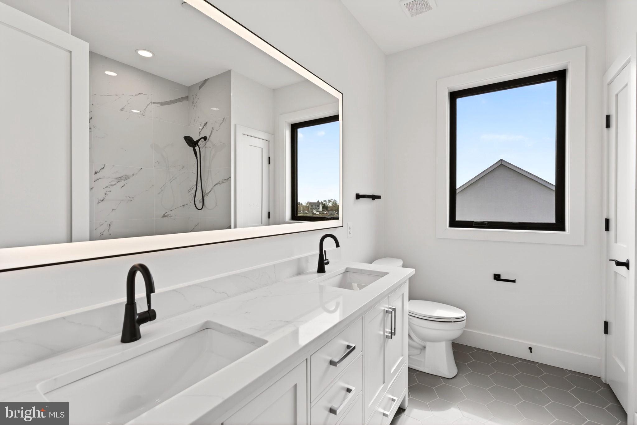 2708 6th Street Sparrows Point, MD 21219 - Photo 64 of 131 a bathroom with a toilet sink and mirror