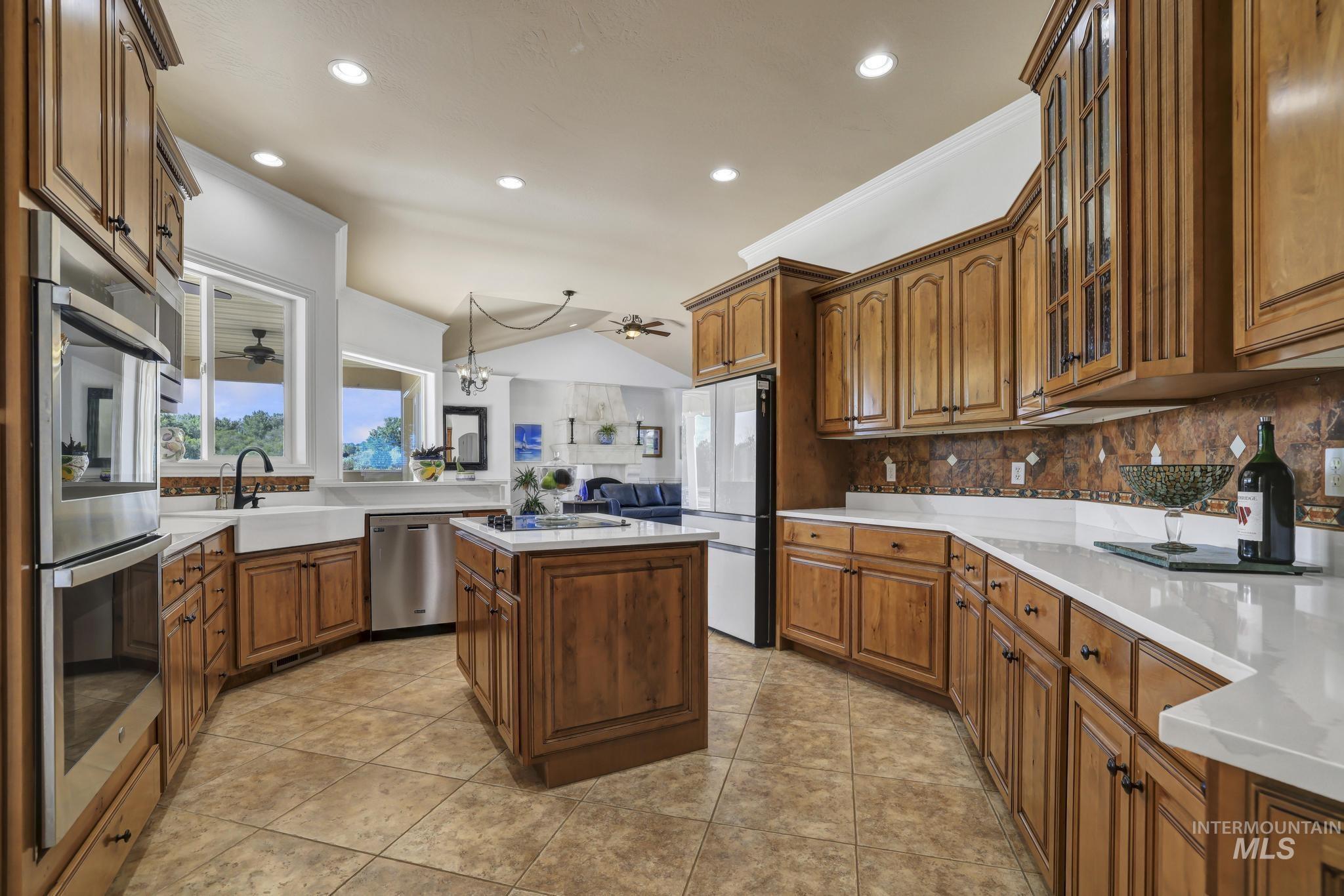 1301 Kanaka Rapids Road Buhl, ID 83316 - Photo 24 of 50 Spacious kitchen featuring warm wood cabinetry, light countertops, an island with countertop, stainless steel appliances, and tile flooring