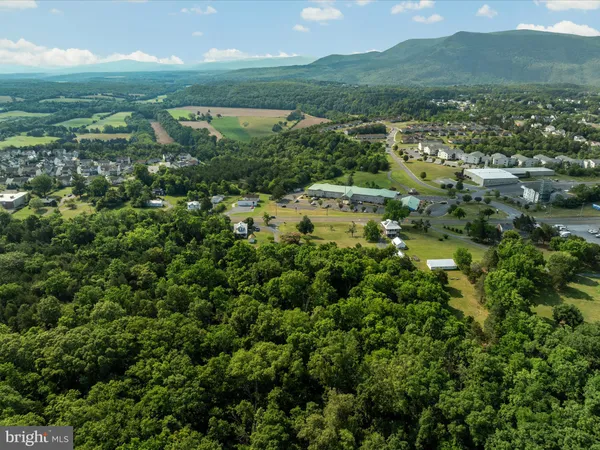 an aerial view of mountains residential house and green space