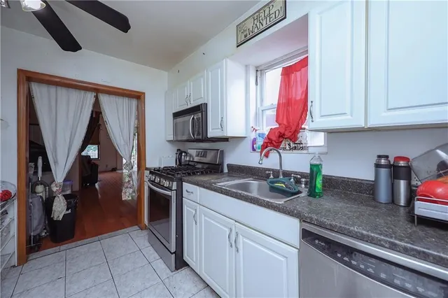 a kitchen with stainless steel appliances granite countertop a sink a stove and a refrigerator
