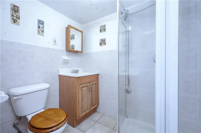 a bathroom with a granite countertop toilet and a sink