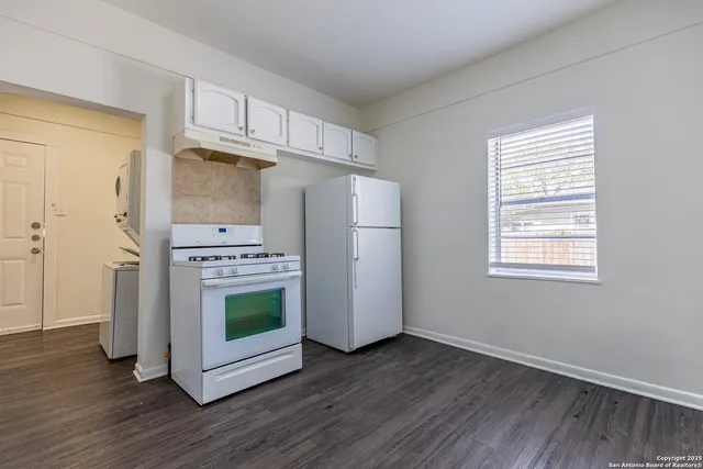 a kitchen with stainless steel appliances a refrigerator microwave and sink