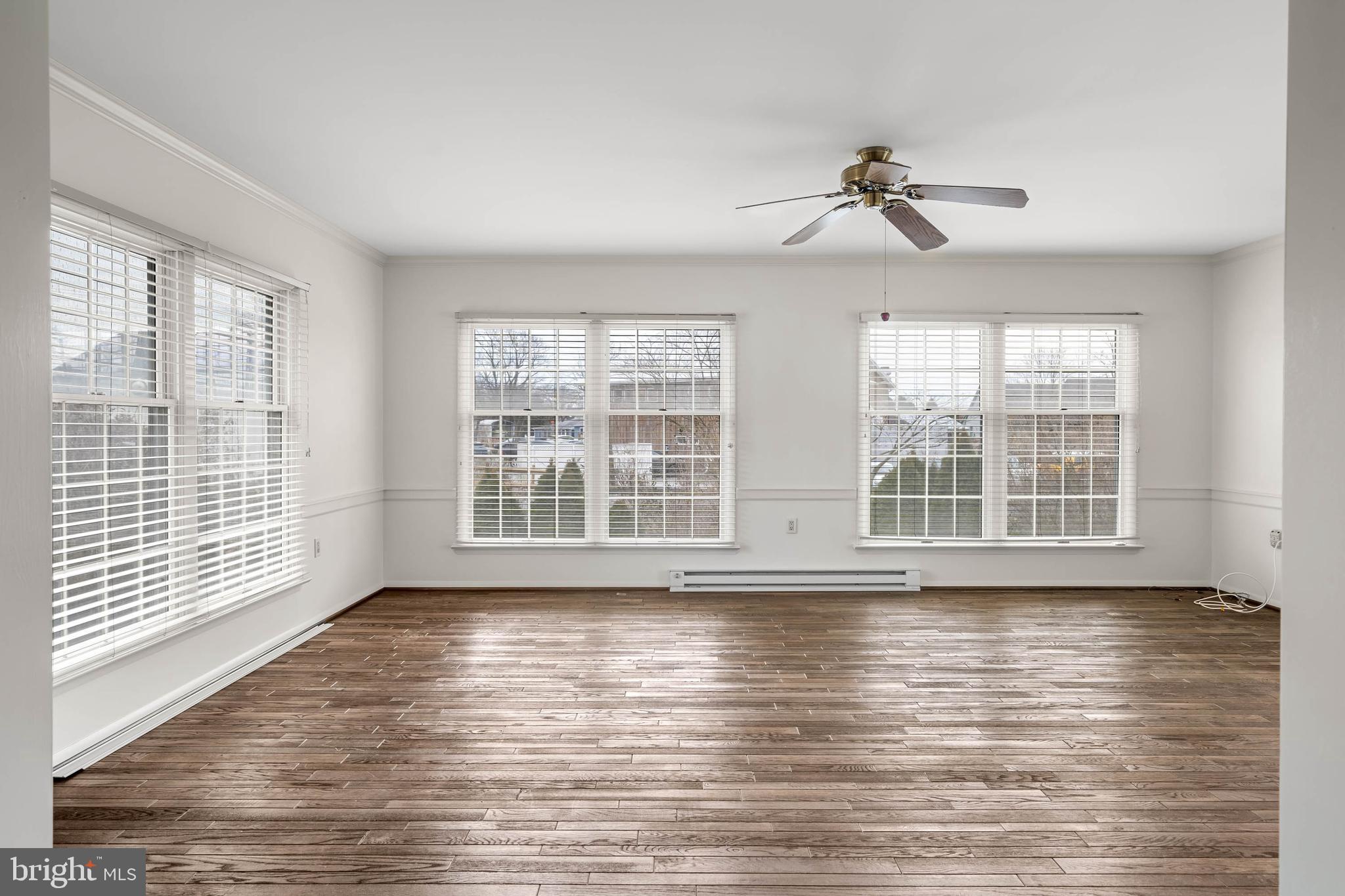 27 Devries Circle Lewes, DE 19958 - Photo 12 of 40 a view of an empty room with wooden floor and a window