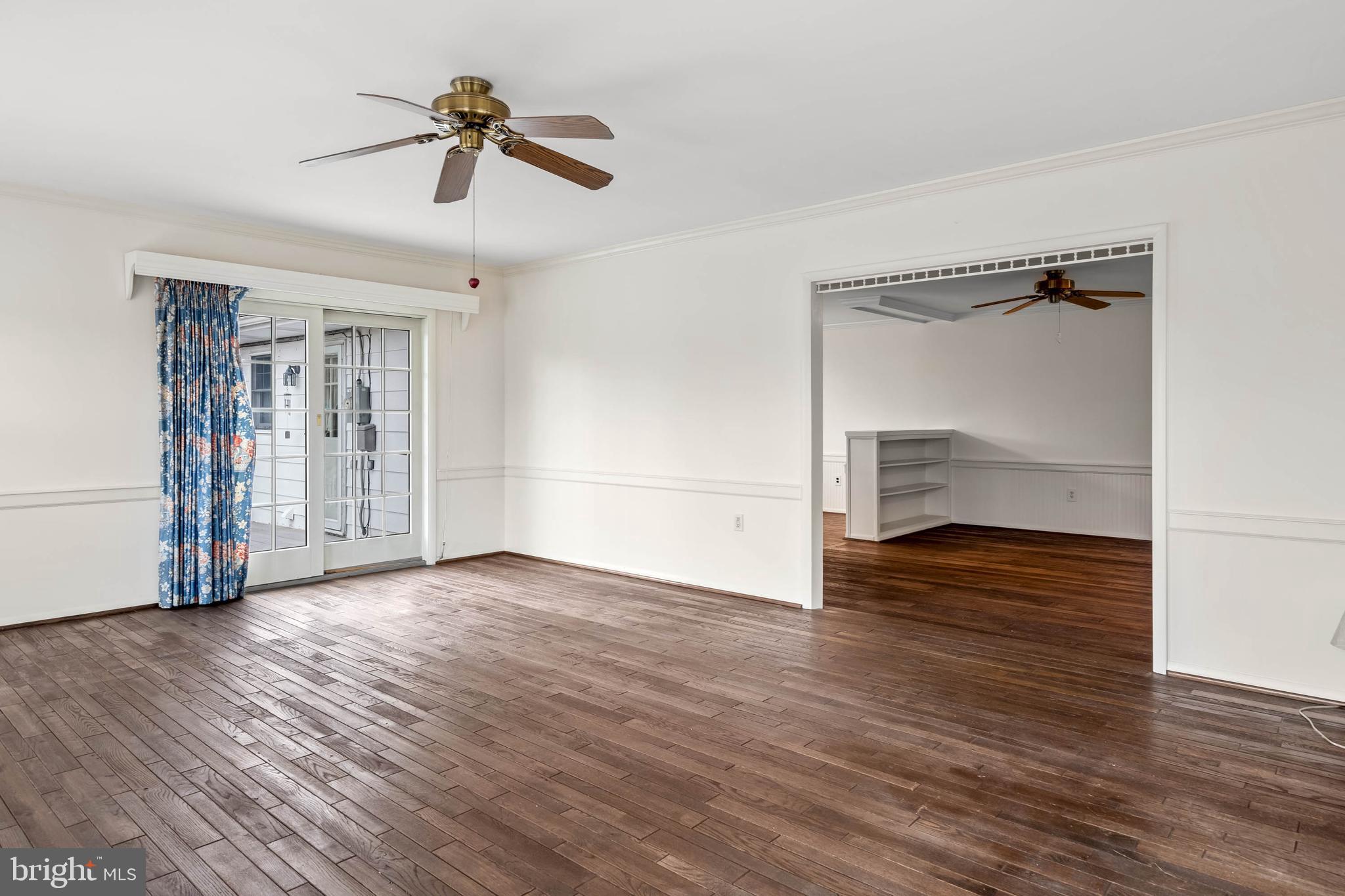 27 Devries Circle Lewes, DE 19958 - Photo 14 of 40 a view of empty room with wooden floor and ceiling fan