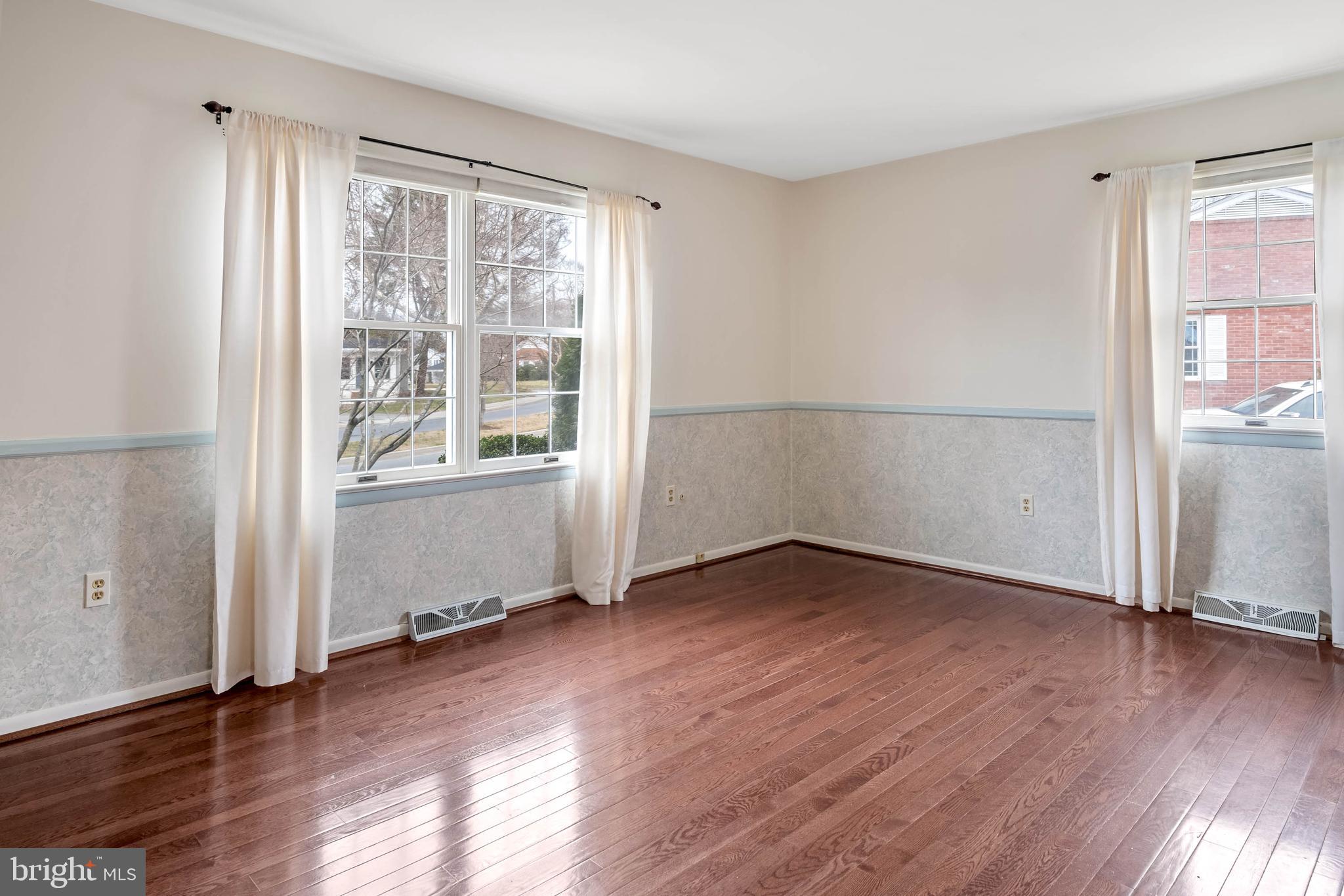 27 Devries Circle Lewes, DE 19958 - Photo 15 of 40 an empty room with wooden floor and windows