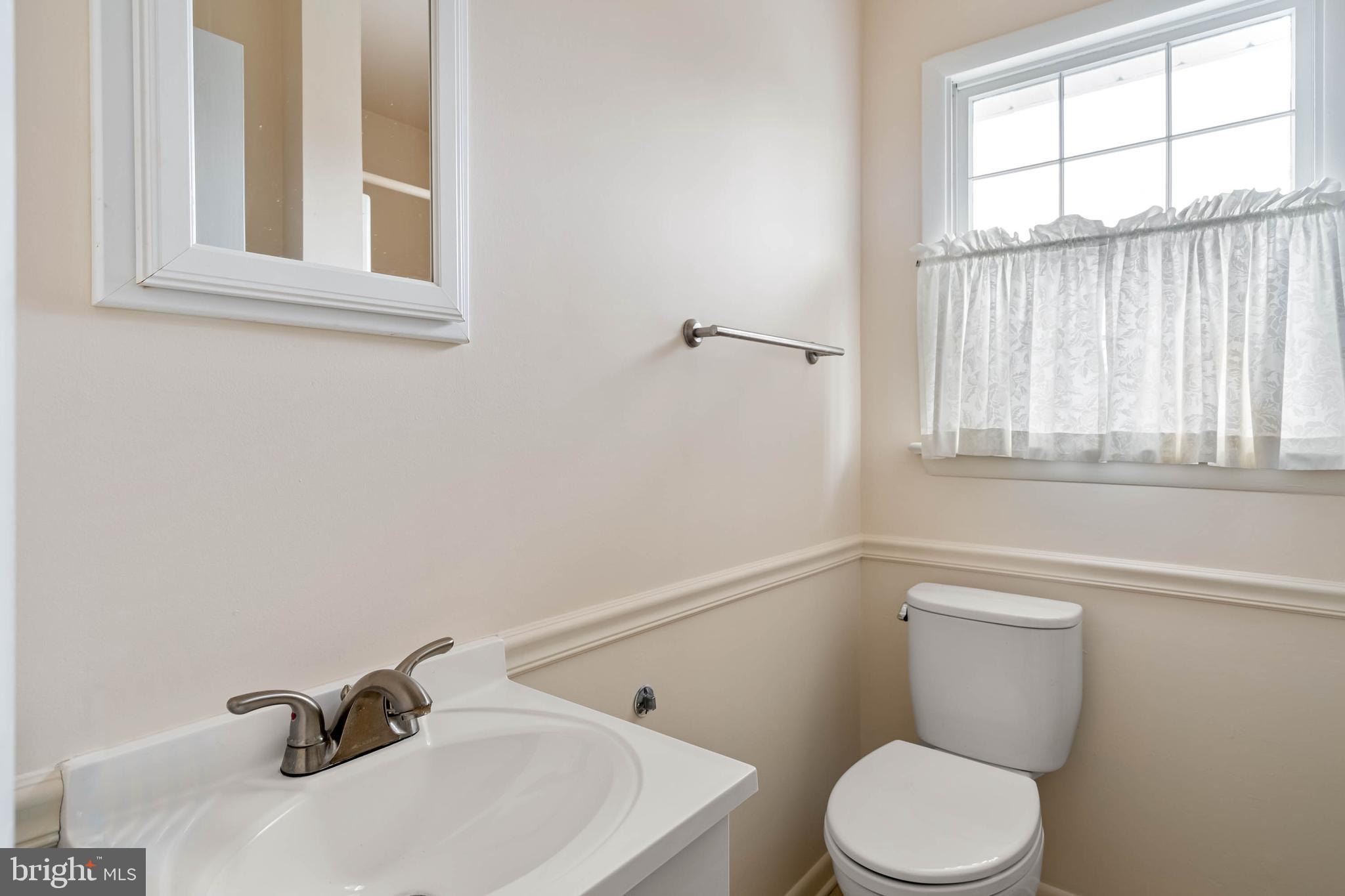 27 Devries Circle Lewes, DE 19958 - Photo 22 of 40 a bathroom with a sink a toilet and a window