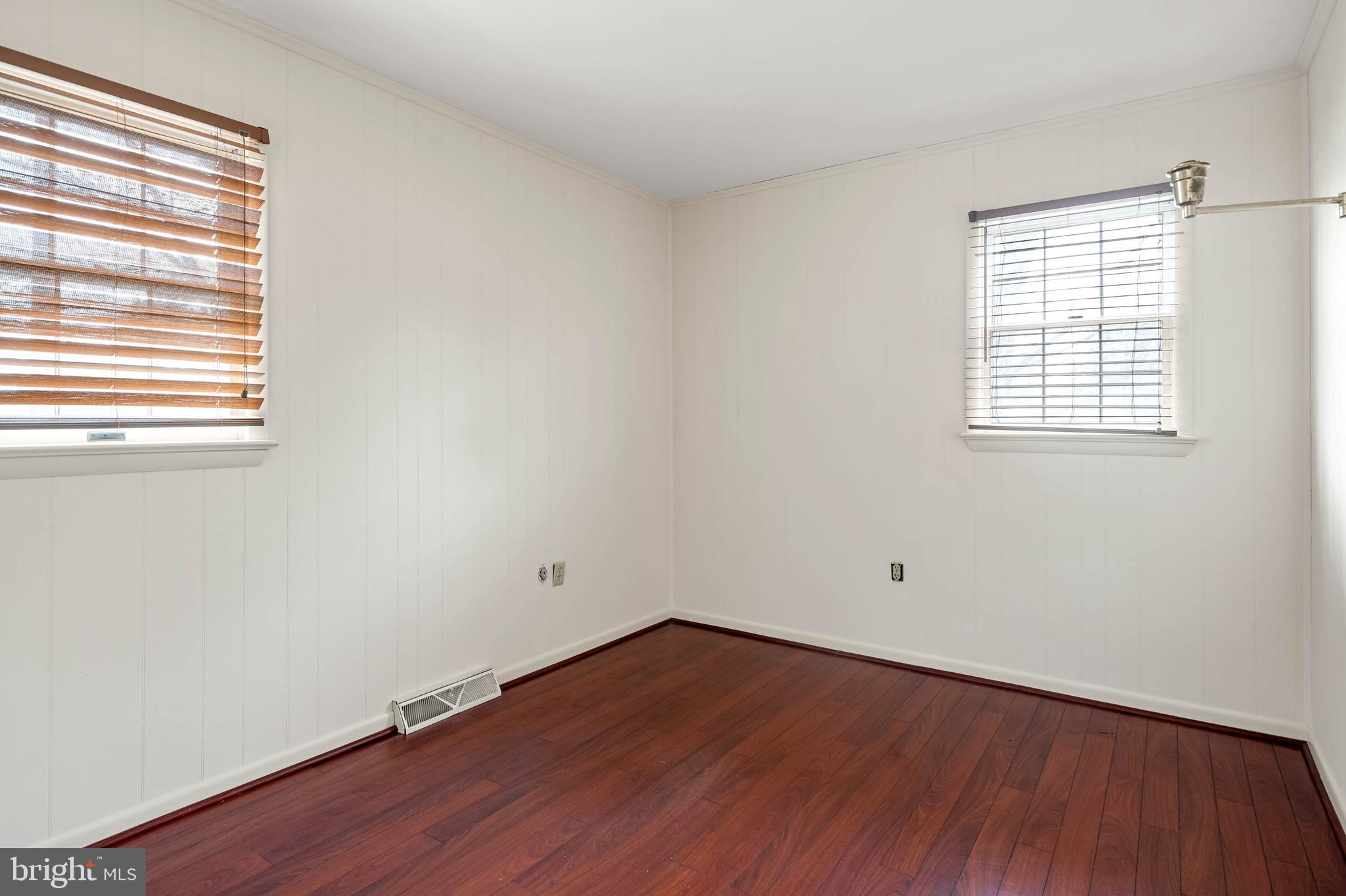 27 Devries Circle Lewes, DE 19958 - Photo 23 of 40 an empty room with wooden floor and windows