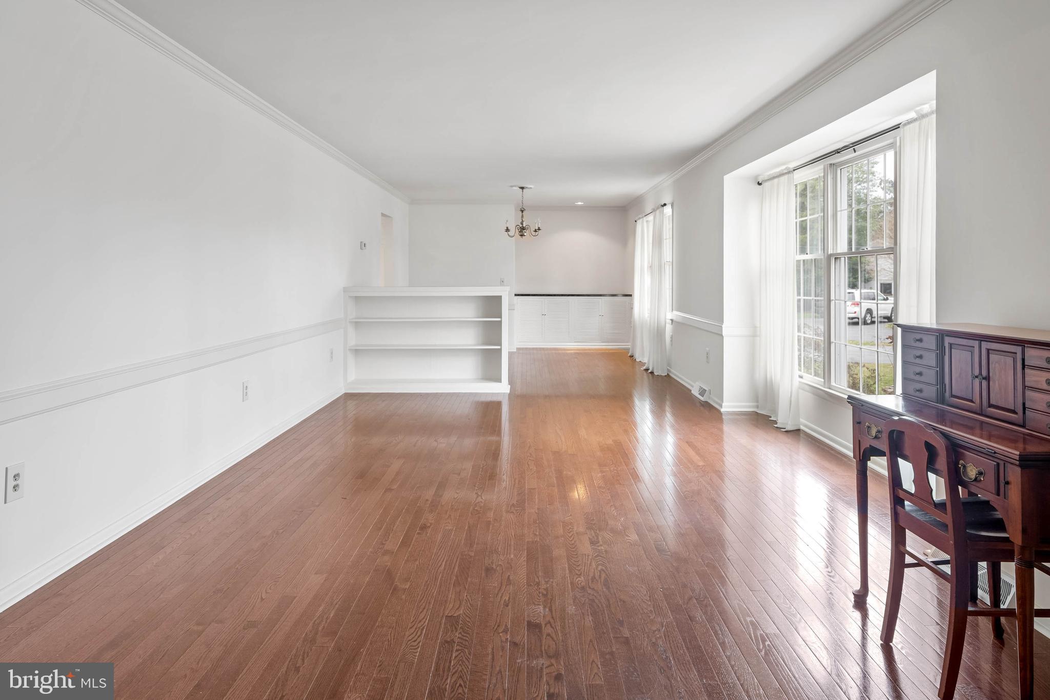 27 Devries Circle Lewes, DE 19958 - Photo 4 of 40 a view of an empty room with wooden floor and a window