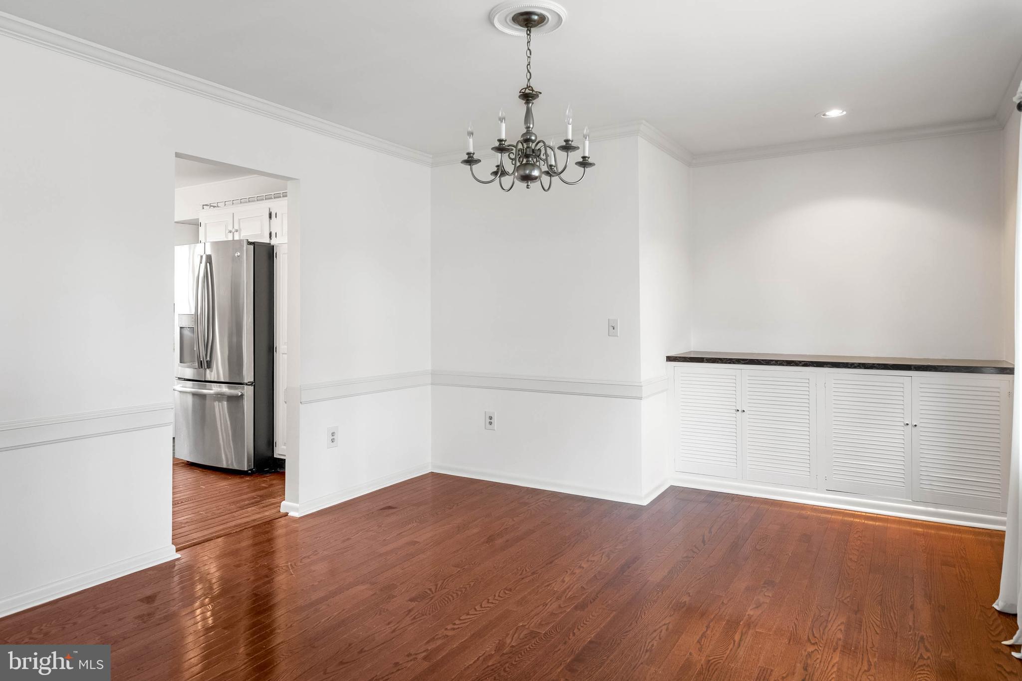 27 Devries Circle Lewes, DE 19958 - Photo 5 of 40 wooden floor in an empty room with a kitchen