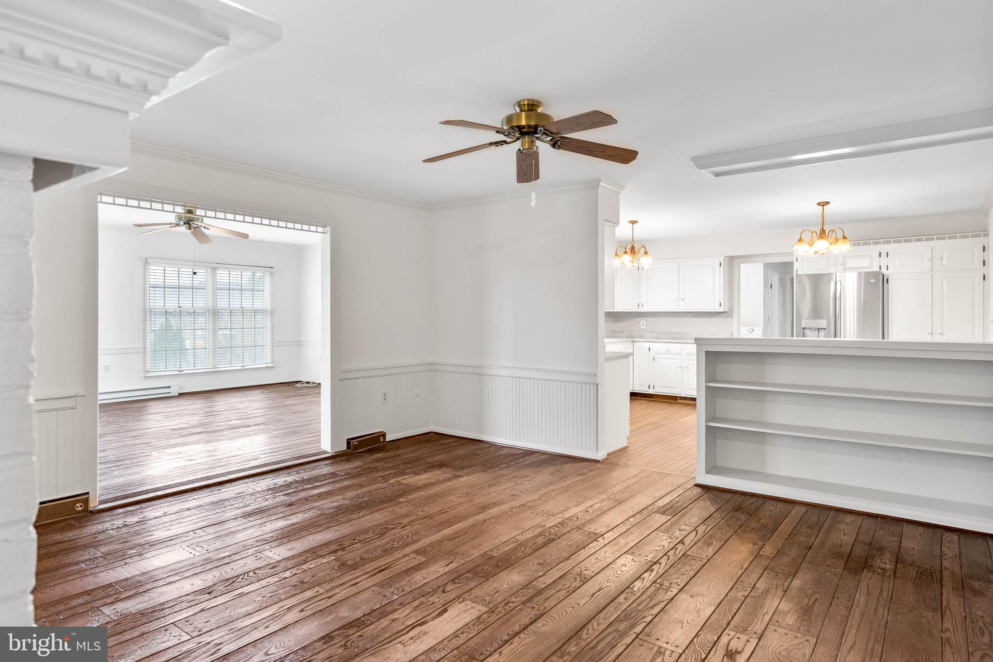 27 Devries Circle Lewes, DE 19958 - Photo 7 of 40 a view of empty room with wooden floor and fan