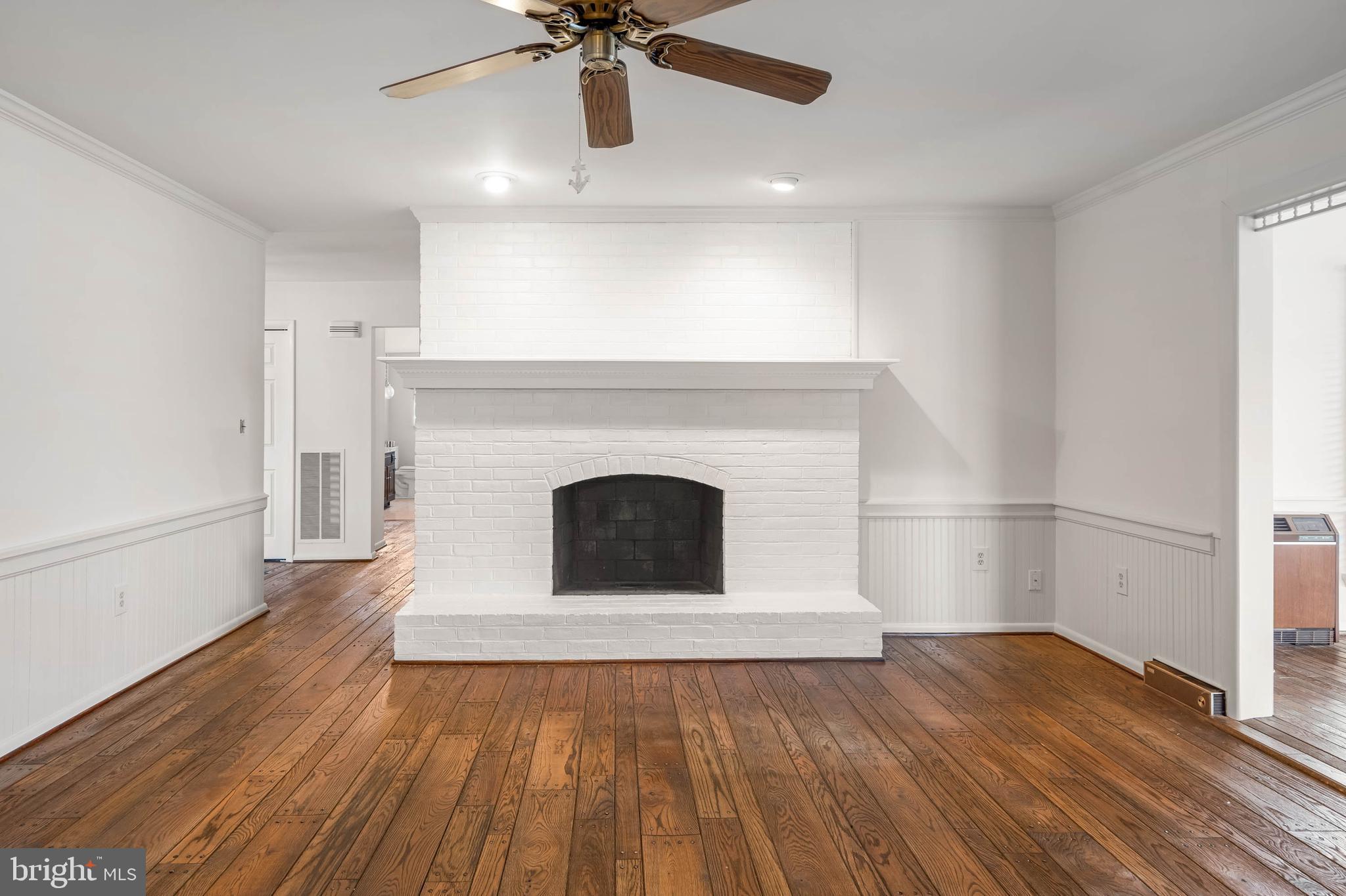 27 Devries Circle Lewes, DE 19958 - Photo 8 of 40 a view of a livingroom with wooden floor and a ceiling fan