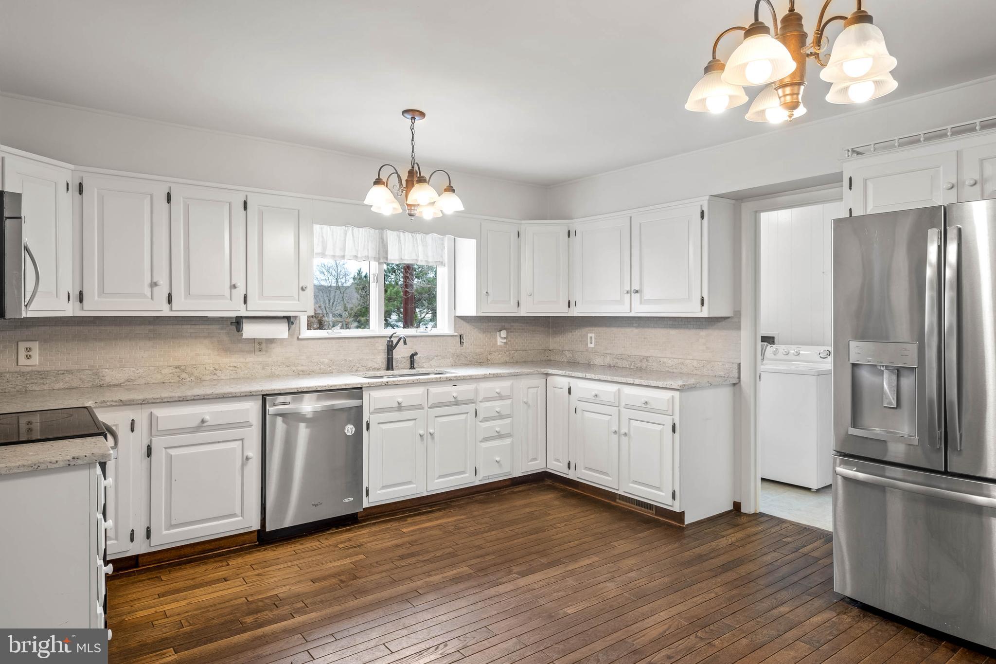 27 Devries Circle Lewes, DE 19958 - Photo 9 of 40 a kitchen with a white cabinets and window