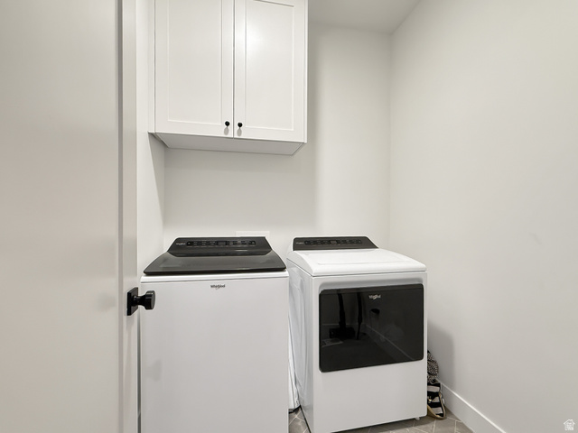916 Rocky Mountain Way Elk Ridge, UT 84651 - Photo 34 of 54 Laundry room with cabinet space and washer and clothes dryer