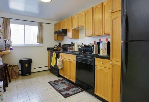 71 Colborne Road, Unit 1B Boston, MA 02135 - Photo 3 of 7 a kitchen with a sink appliances and cabinets