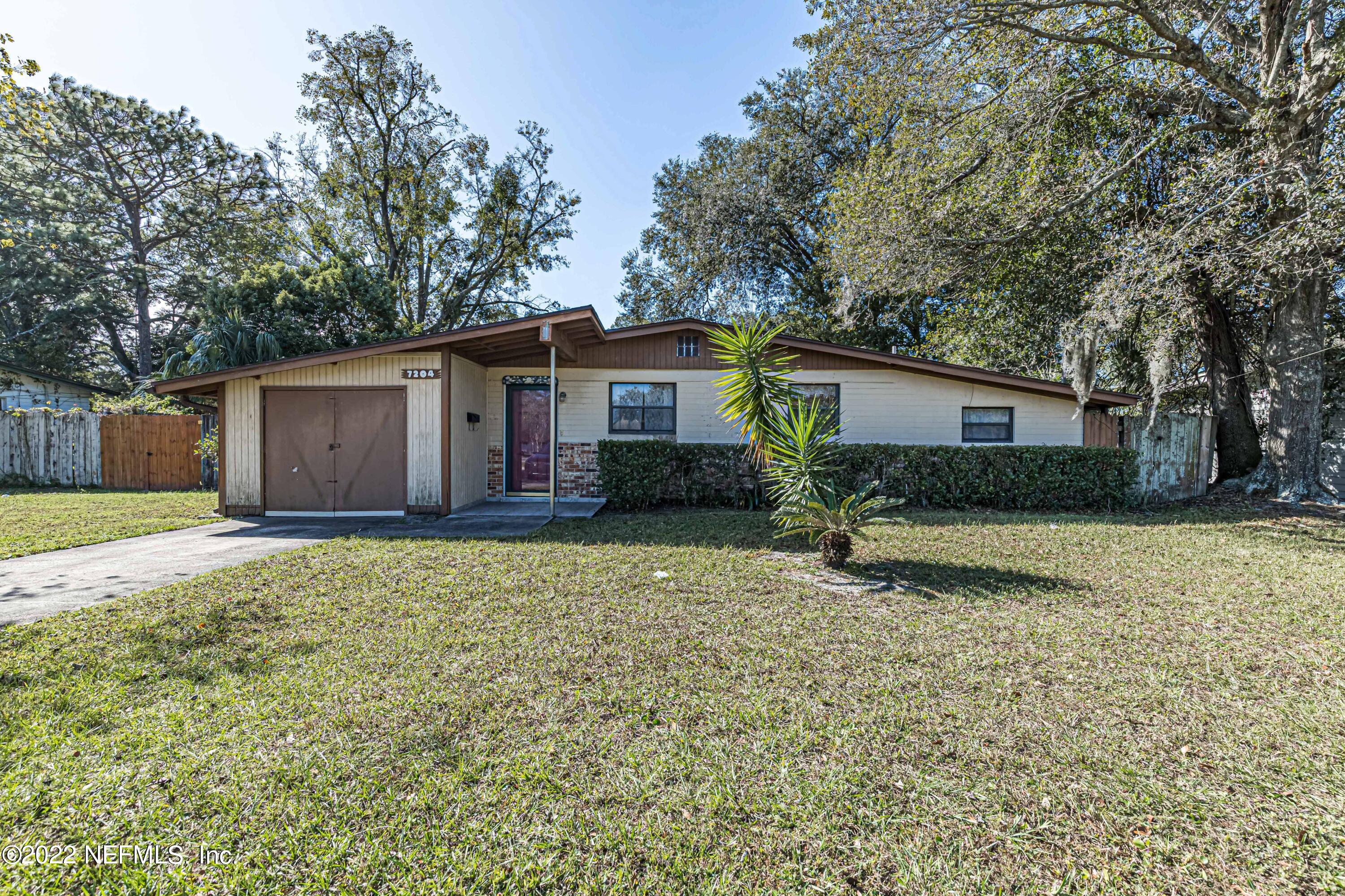 7204 Old Kings Road South Jacksonville, FL 32217 - Photo 1 of 32 a house with trees in the background