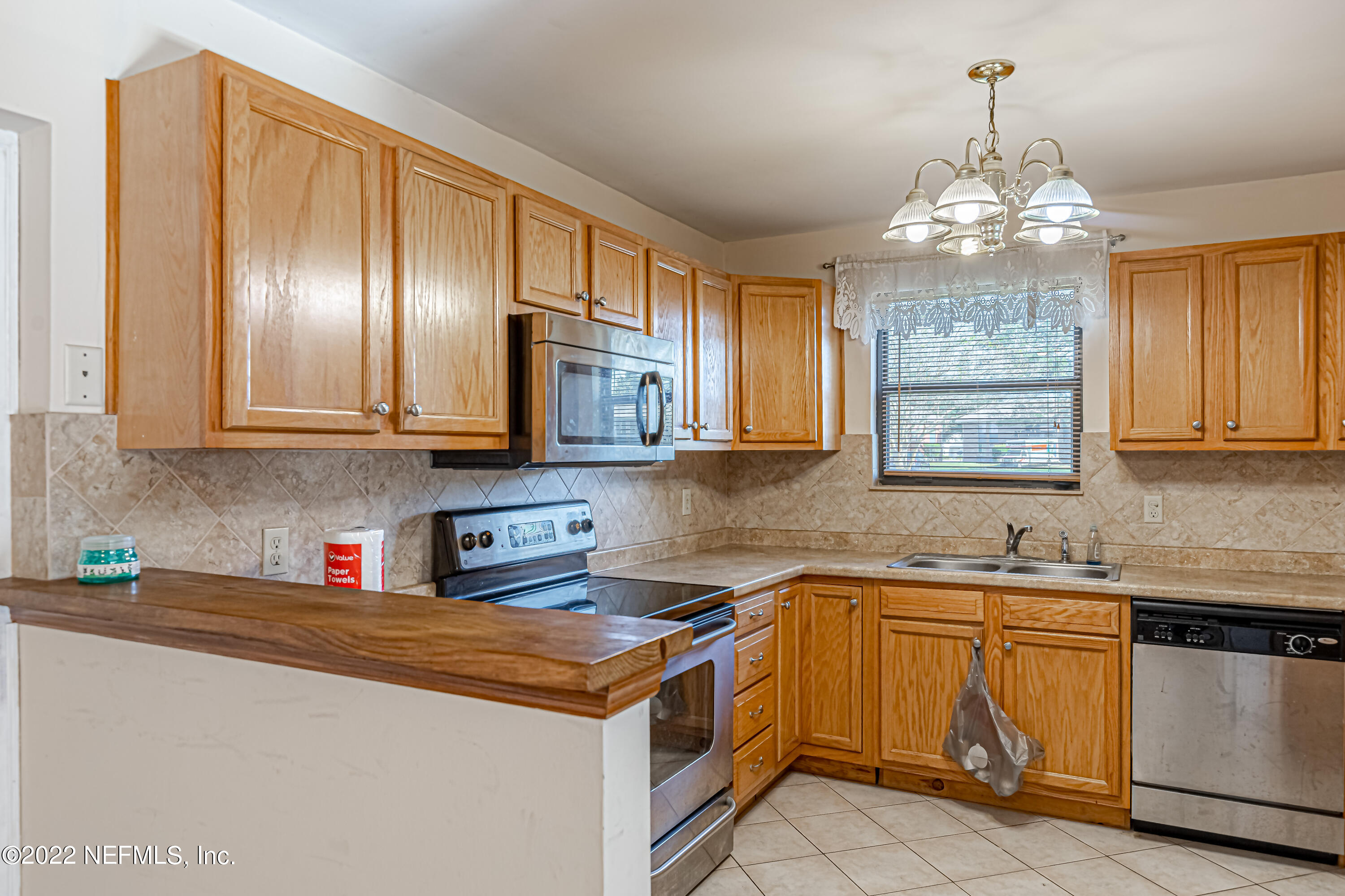 7204 Old Kings Road South Jacksonville, FL 32217 - Photo 12 of 32 a kitchen with stainless steel appliances granite countertop a sink stove and cabinets
