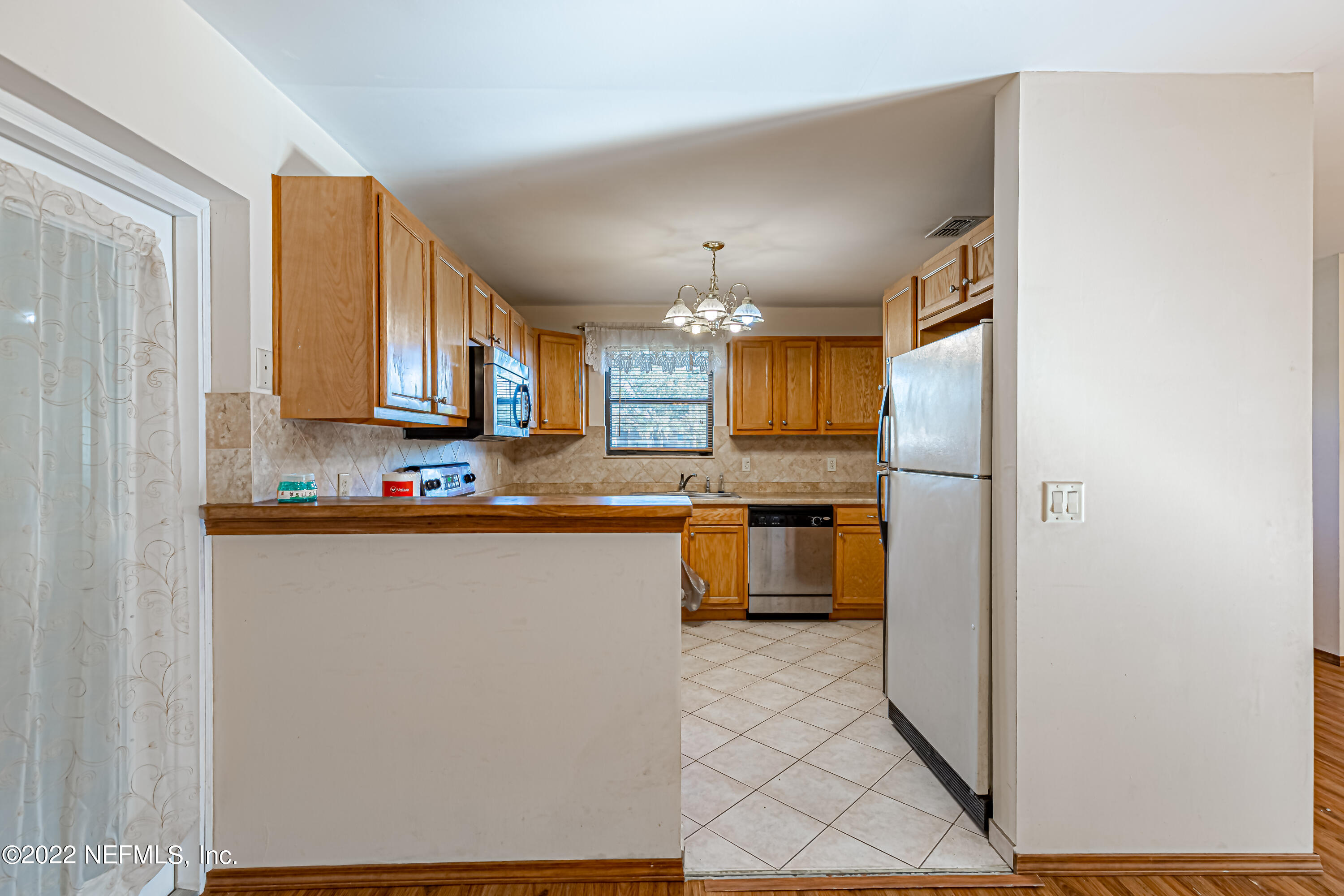 7204 Old Kings Road South Jacksonville, FL 32217 - Photo 13 of 32 a kitchen with stainless steel appliances a refrigerator a sink a stove top oven a counter space and cabinets