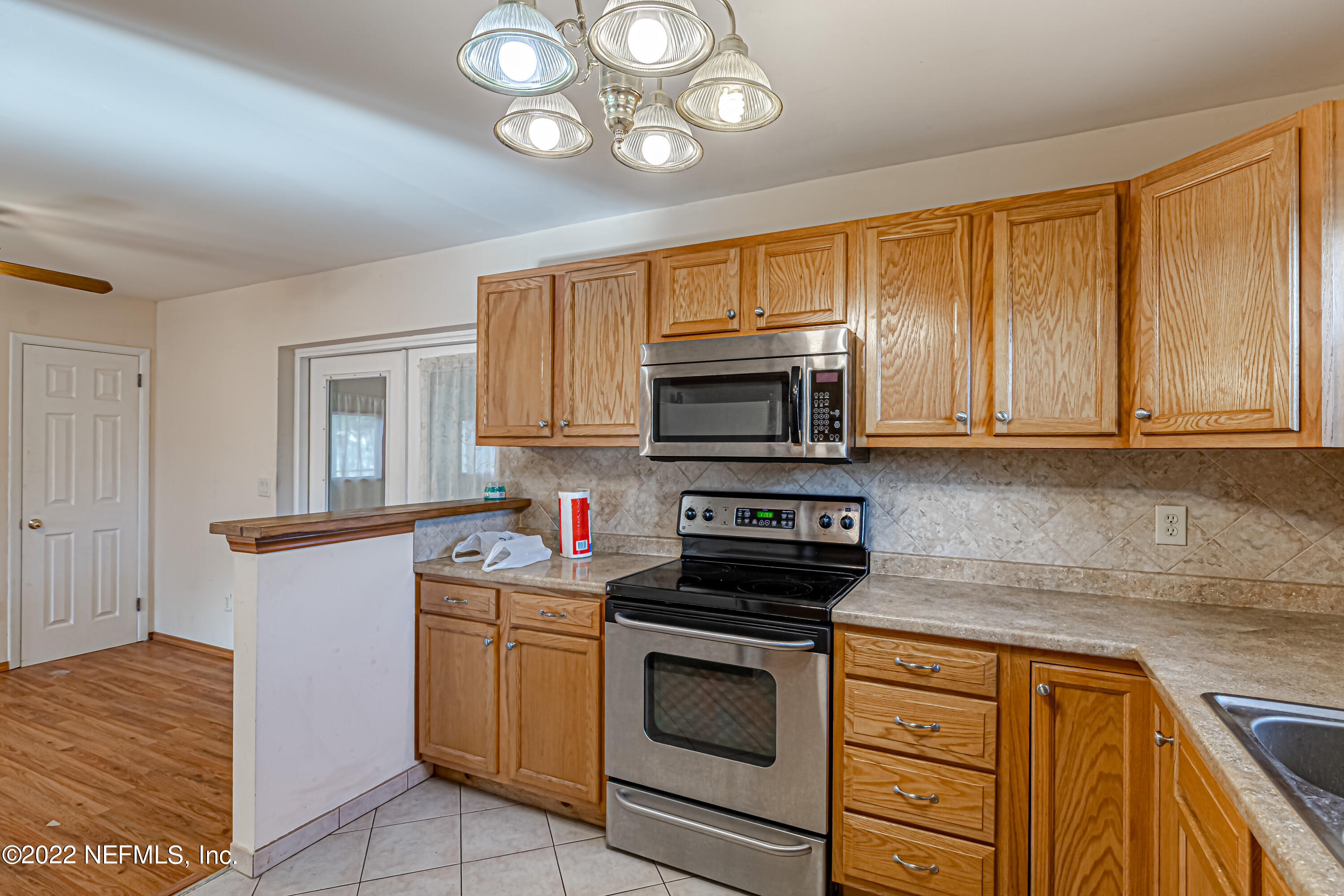 7204 Old Kings Road South Jacksonville, FL 32217 - Photo 15 of 32 a kitchen with stainless steel appliances granite countertop a sink dishwasher stove and cabinets with wooden floor