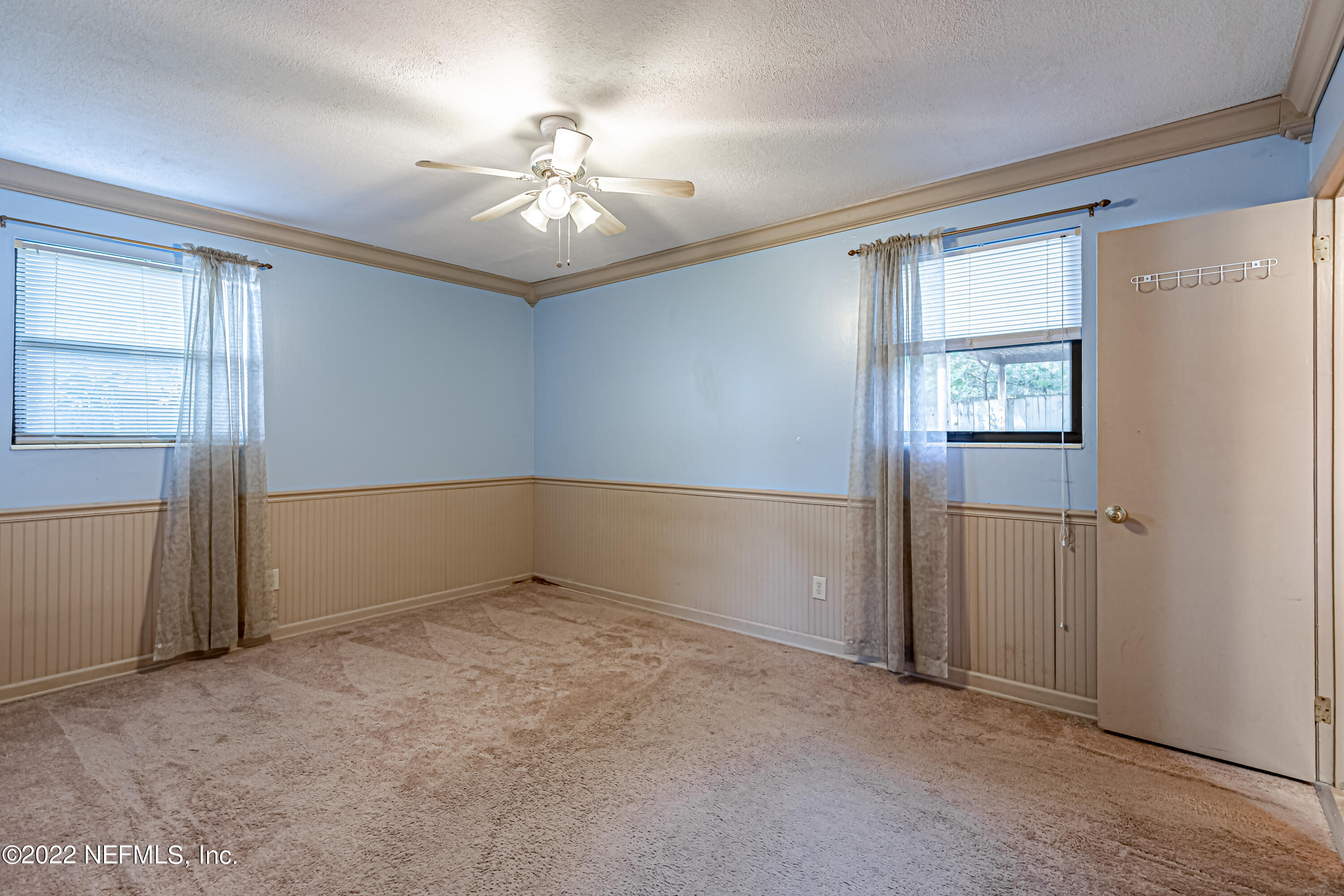 7204 Old Kings Road South Jacksonville, FL 32217 - Photo 20 of 32 an empty room with chandelier fan and windows