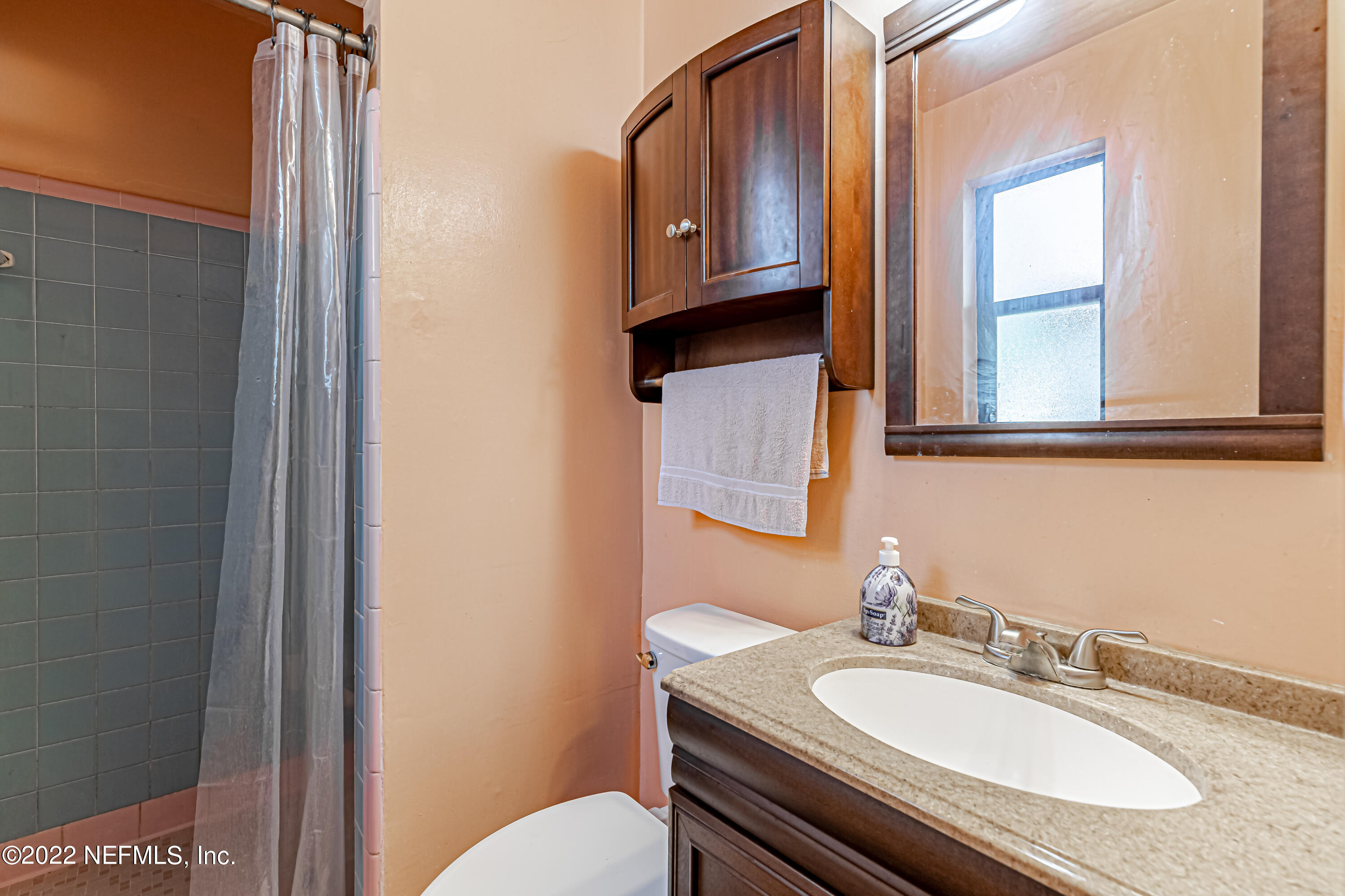 7204 Old Kings Road South Jacksonville, FL 32217 - Photo 23 of 32 a bathroom with a granite countertop toilet sink and mirror