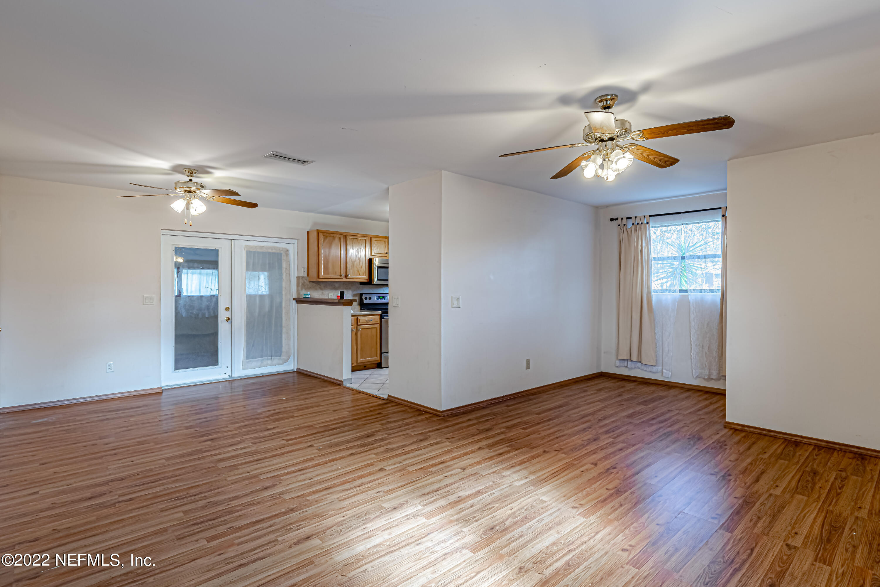 7204 Old Kings Road South Jacksonville, FL 32217 - Photo 8 of 32 a view of empty room with wooden floor and ceiling fan