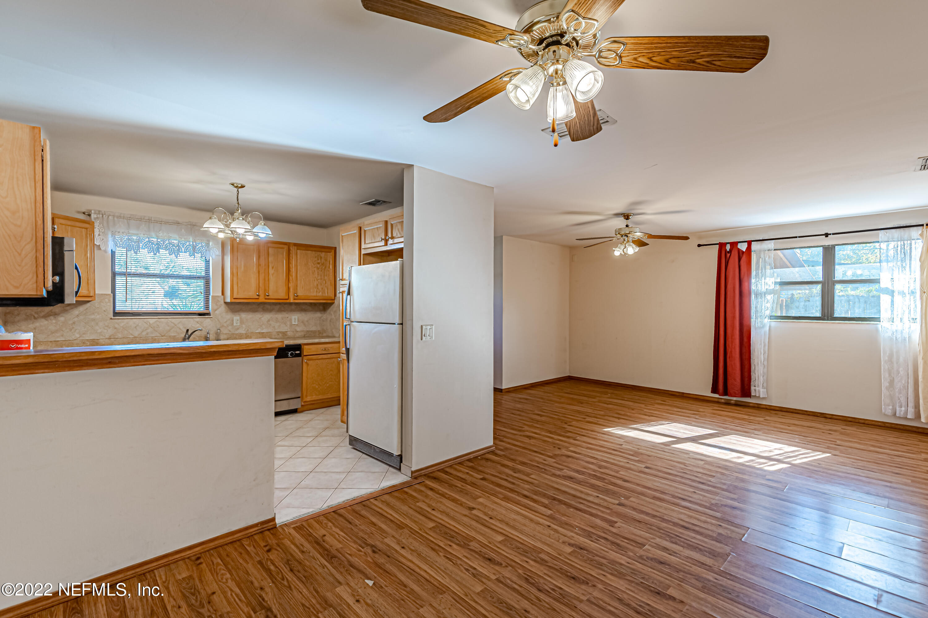 7204 Old Kings Road South Jacksonville, FL 32217 - Photo 10 of 32 a view of a kitchen with wooden floor and a ceiling fan