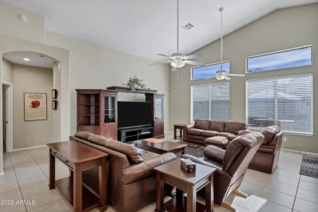 a living room with furniture a flat screen tv and a large window