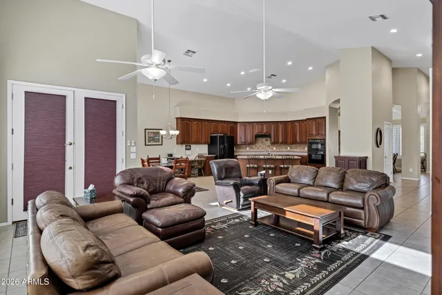 a living room with furniture a ceiling fan and a rug