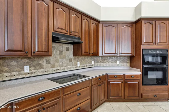 a kitchen with stainless steel appliances granite countertop a sink and cabinets