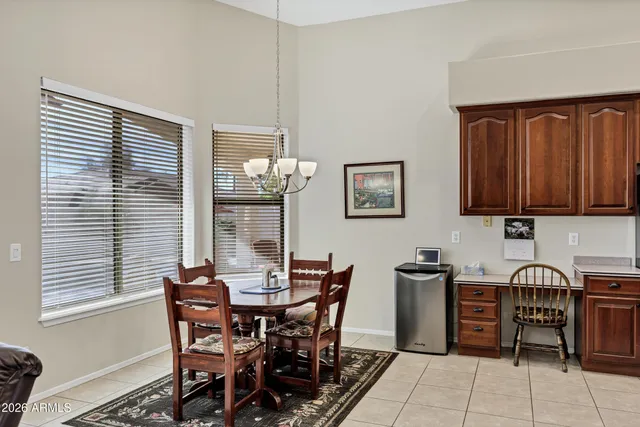 a view of a dining room with furniture and chandelier