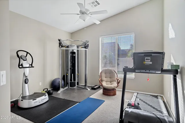 a living room with furniture a flat screen tv and a window