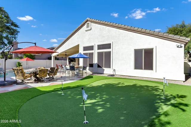 a view of a house with backyard porch and sitting area