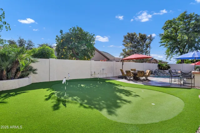 a swimming pool with outdoor seating and yard