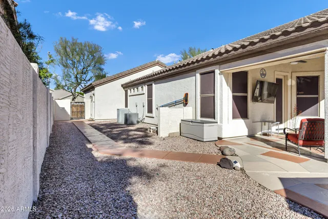 a view of a house with backyard and sitting area