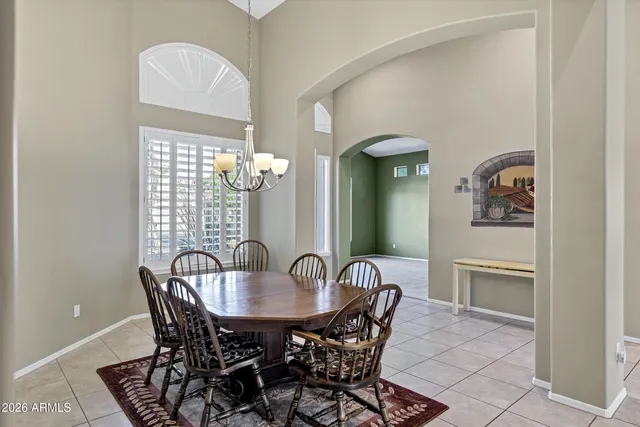 a view of a dining room with furniture and chandelier