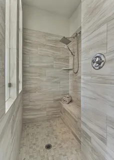 a bathroom with a tub a sink and a mirror