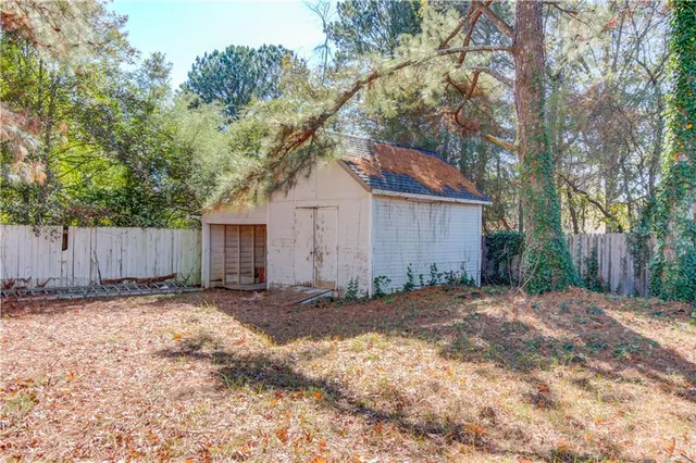 a view of a backyard with a large tree