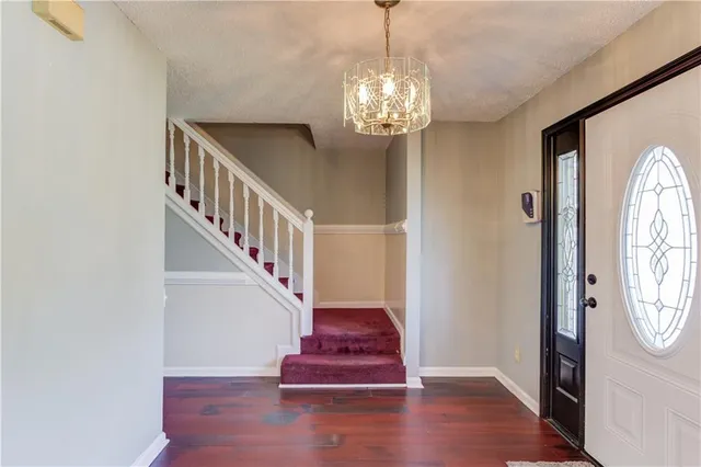 a view of an entryway with wooden floor
