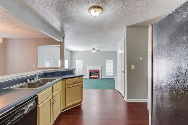 a view of a kitchen counter space a sink and dishwasher