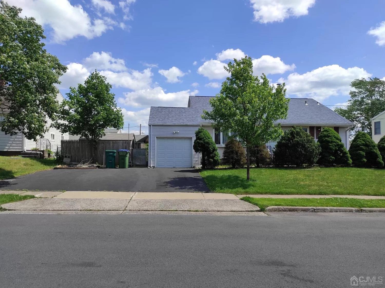 29 Sims Road Edison, NJ 08817 - Photo 1 of 1 a front view of a house with a yard and a garage