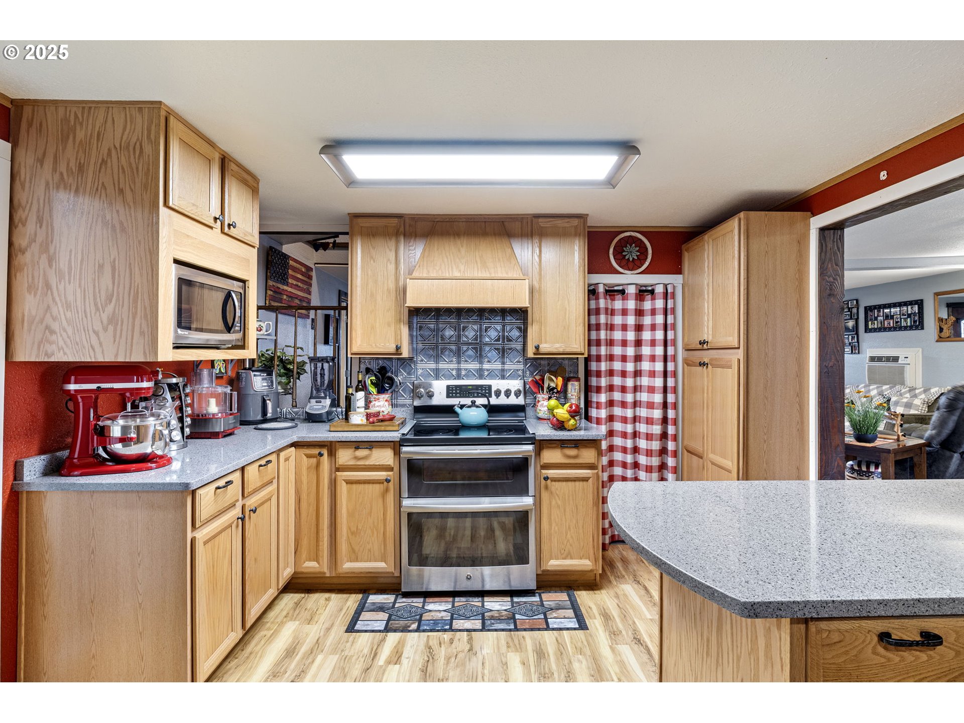 252 Alder Street Yoncalla, OR 97499 - Photo 23 of 47 a kitchen with stainless steel appliances granite countertop a stove a sink dishwasher and cabinets with wooden floor