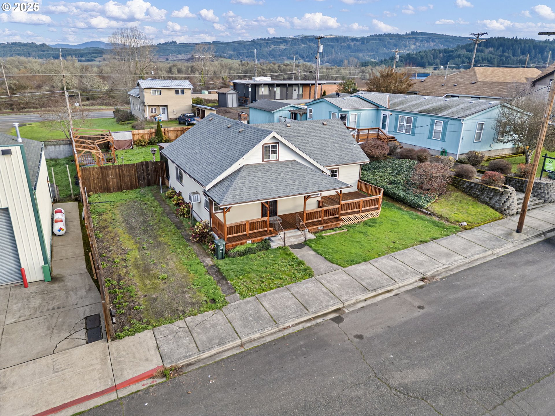 252 Alder Street Yoncalla, OR 97499 - Photo 6 of 47 an aerial view of a house with a garden and a car parked