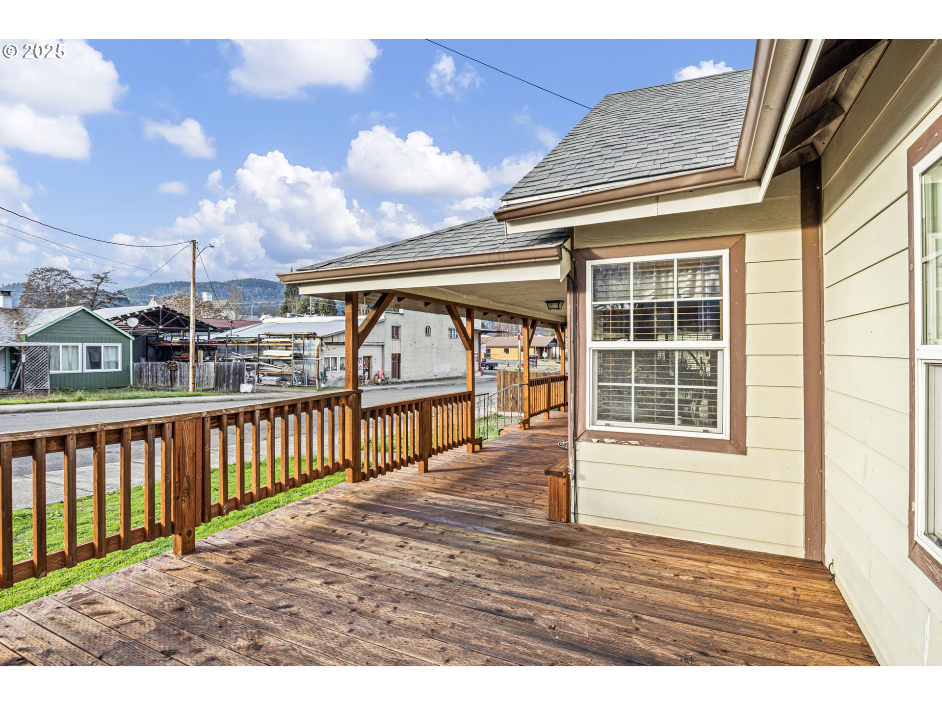 252 Alder Street Yoncalla, OR 97499 - Photo 9 of 47 a view of a porch with wooden floor and floor to ceiling window